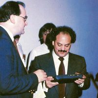 Sam Tramiel, president of video game company Atari, with Atari Lynx handheld video game