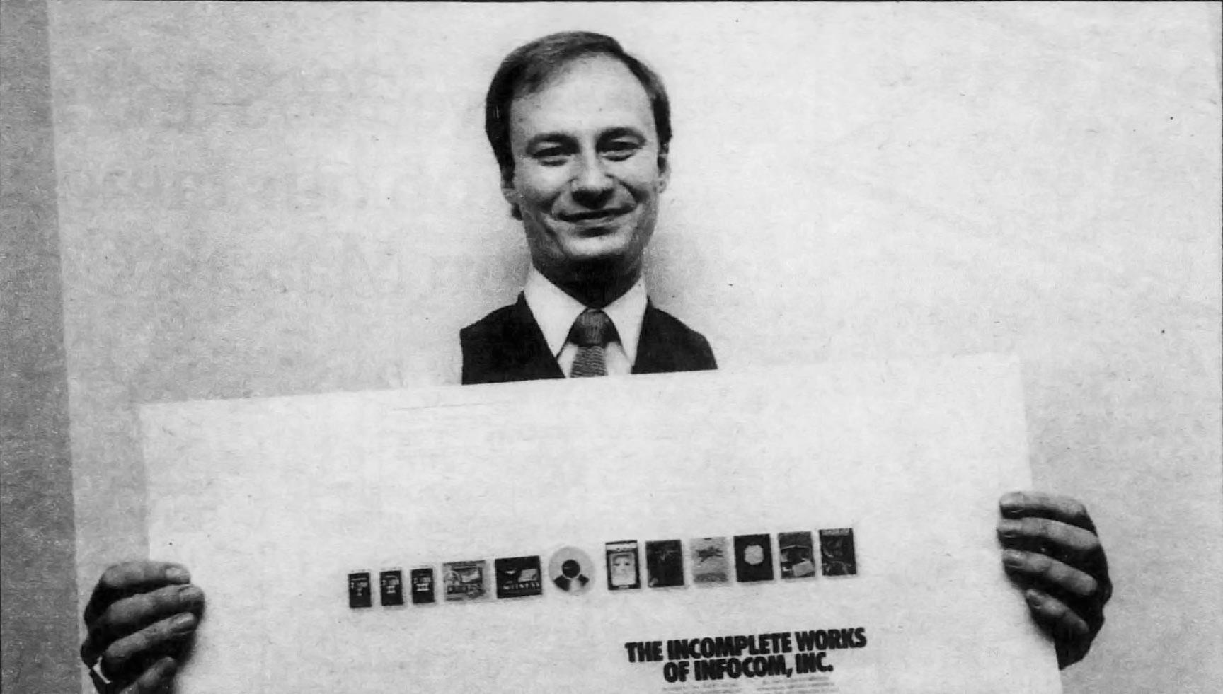 Mike Dornbrook holds an ad for computer text adventure game company Infocom