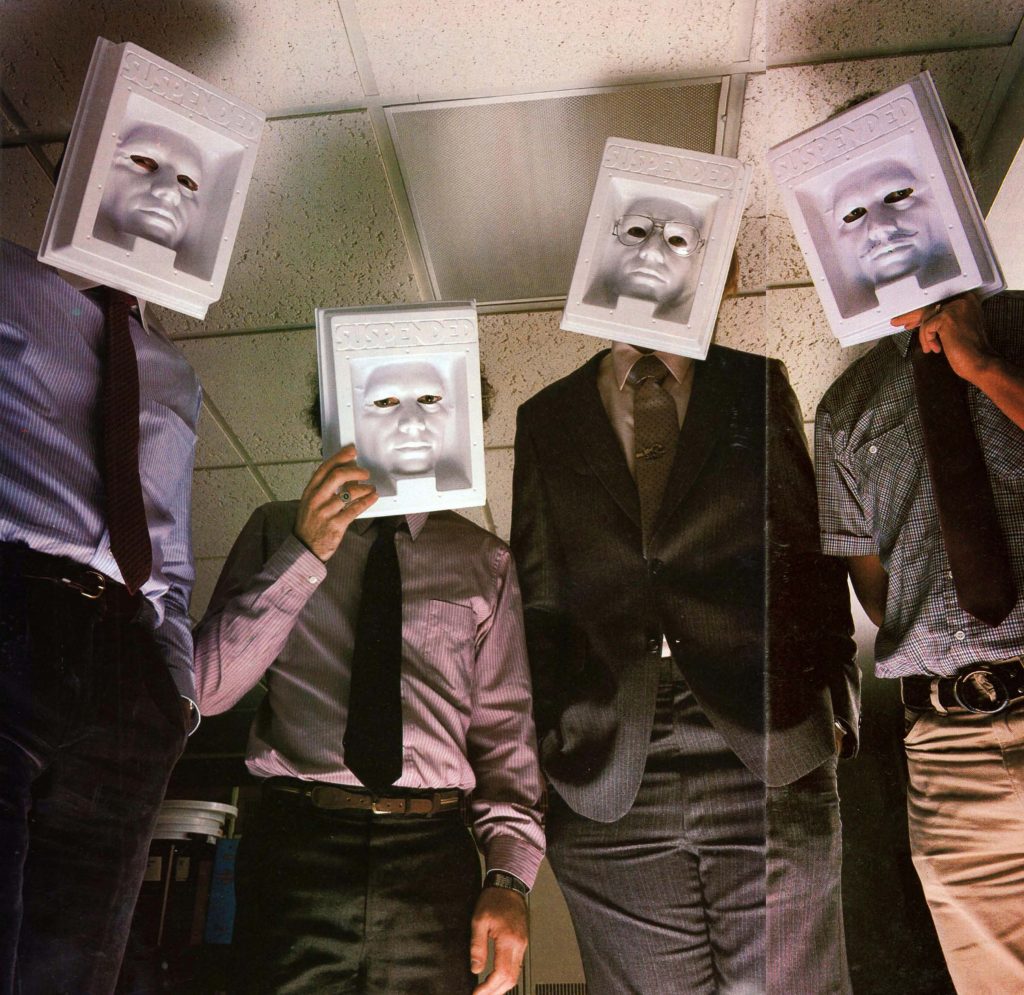 Programmers at computer game company Infocom, hiding behind Suspended masks